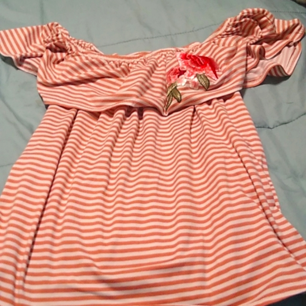 A striped beige and white off the shoulder top